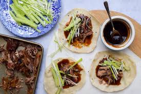 Peking Duck: Crispy duck served with thin pancakes and hoisin sauce.